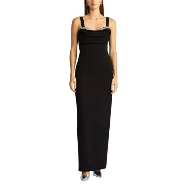 Aglow: Her sleeveless peekaboo gown allowed Cardi to show off her cleavage which she has confessed to having had augmented